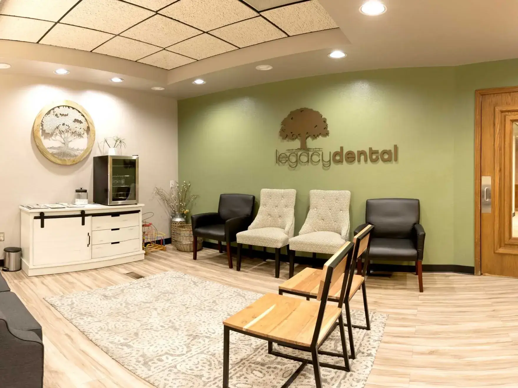A waiting room with chairs and a television.
